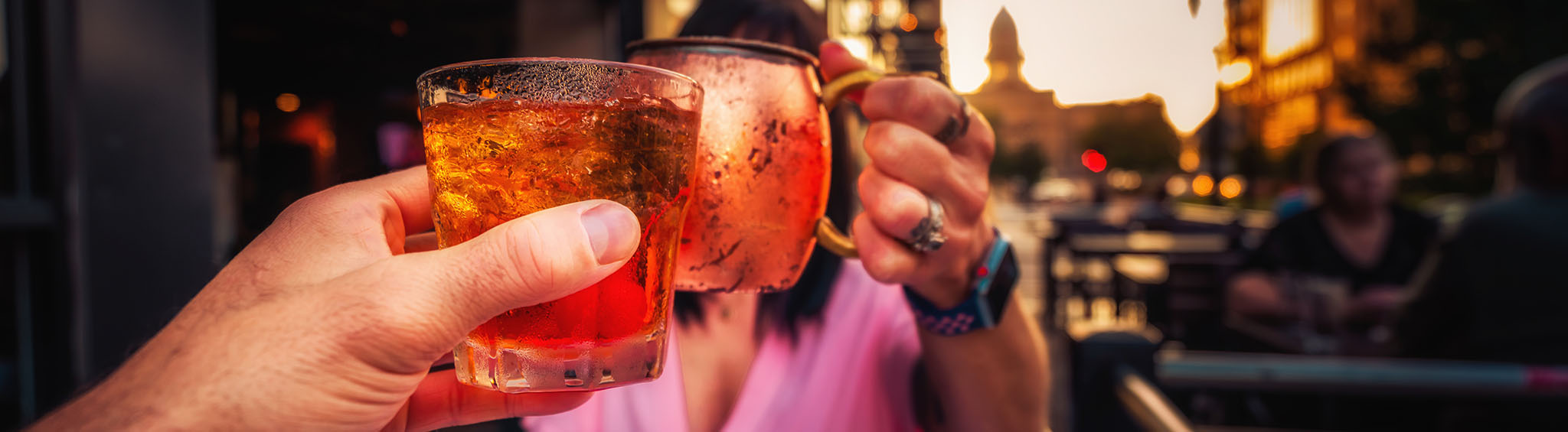 People toasting glasses at downtown Lansing bar